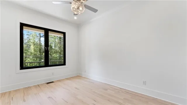an empty room with windows and closet