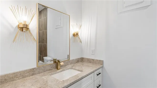 a bathroom with a sink a mirror and a shower