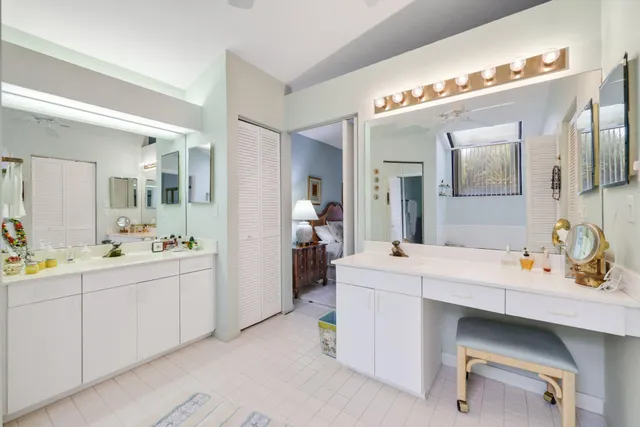 a spacious bathroom with a double vanity sink mirror and