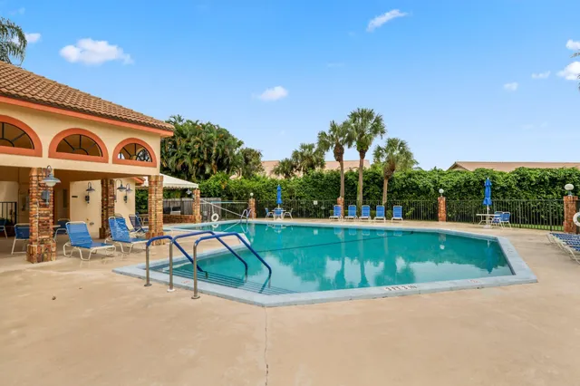 a view of a swimming pool with a bench and a tables