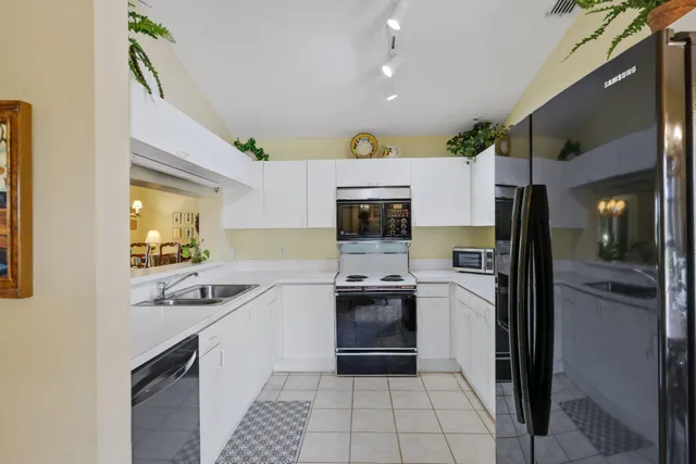 a kitchen with a sink stainless steel appliances and cabinets