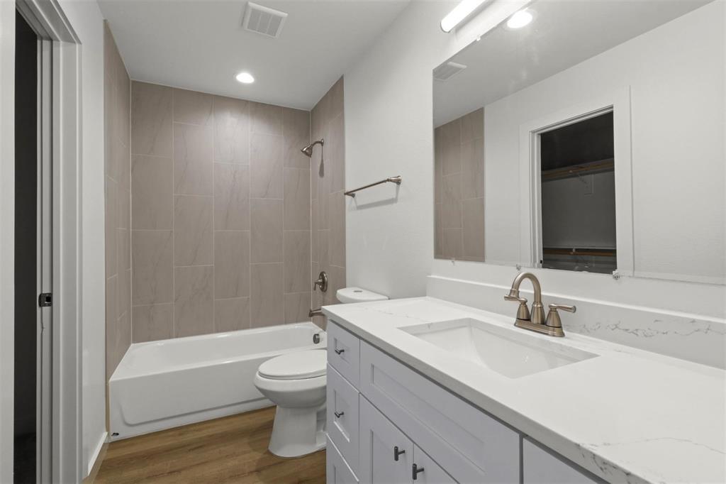 312 East Shepherd Street, Unit 312 Denison, TX 75021 - Photo 12 of 15 a bathroom with a sink a toilet and shower
