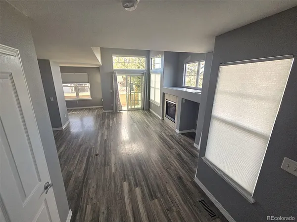 a view of hallway with wooden floor and furniture
