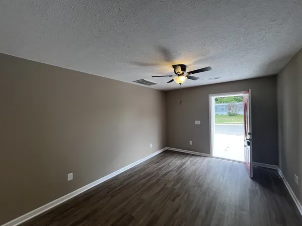 a view of wooden floor and chandelier in a room