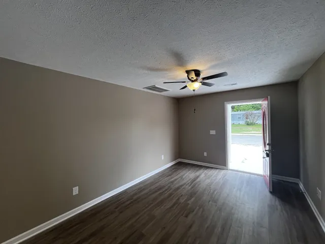 a view of wooden floor and chandelier in a room