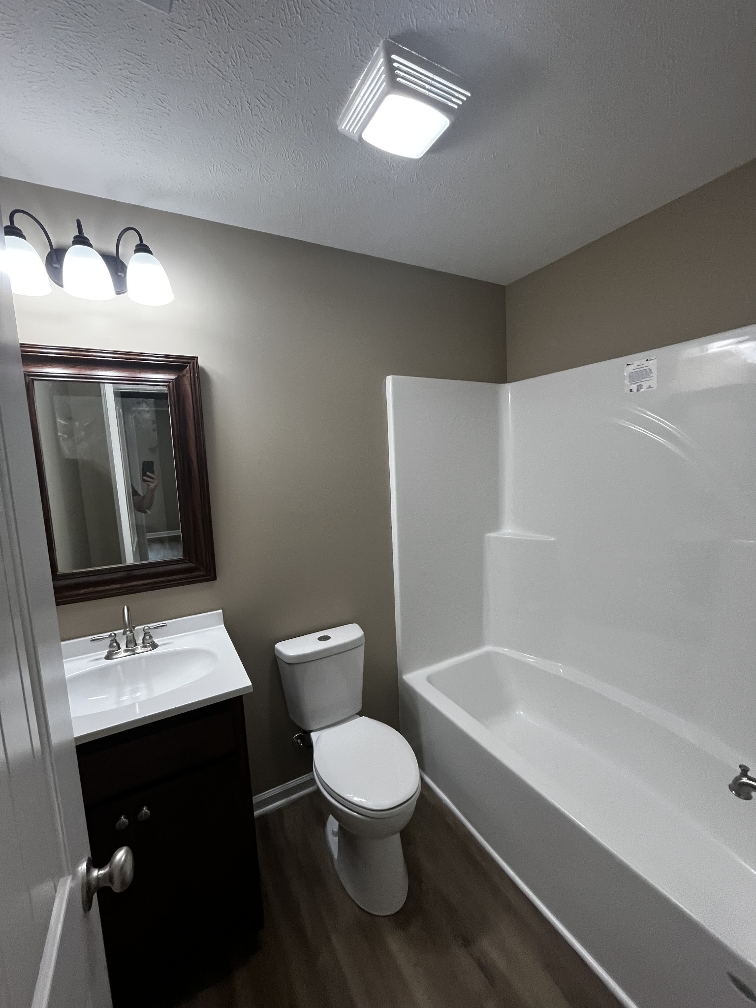 209 Thomas Street Tullahoma, TN 37388 - Photo 5 of 8 a bathroom with a toilet sink and mirror
