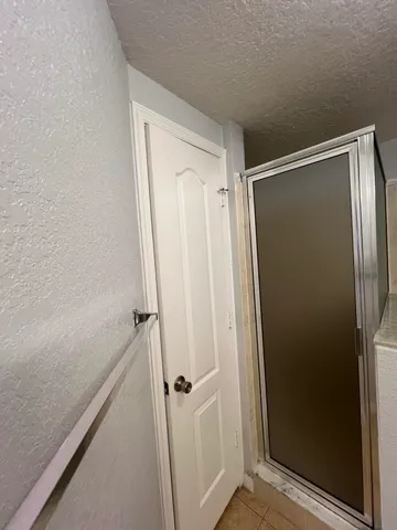 a bathroom with a glass shower door