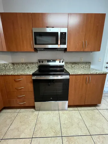 a kitchen with a stove and a microwave