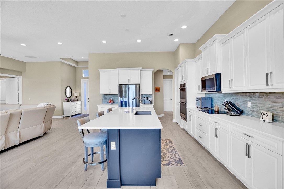 105 Night Hawk Way Sebastian, FL 32958 - Photo 10 of 36 a large kitchen with kitchen island a sink table and chairs