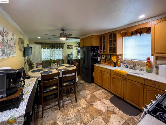 a kitchen with a table chairs refrigerator and microwave
