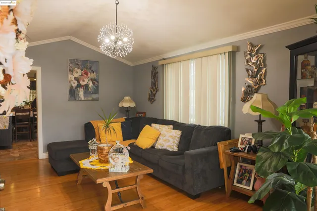 a living room with furniture and a chandelier