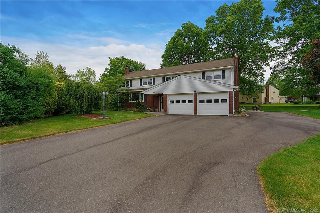 a house with a yard and a large parking space