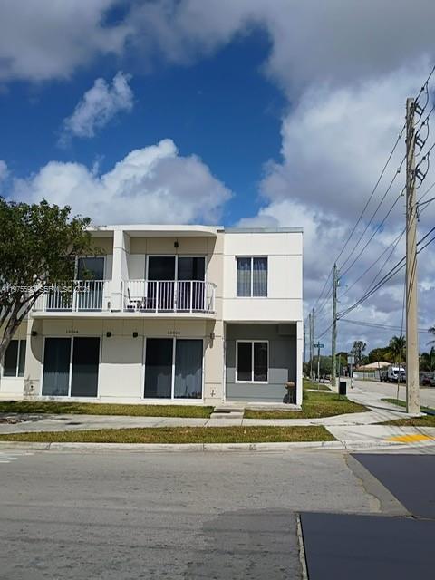 13900 Southwest 259th Street Homestead, FL 33032 - Photo 1 of 23 a front view of residential houses with yard
