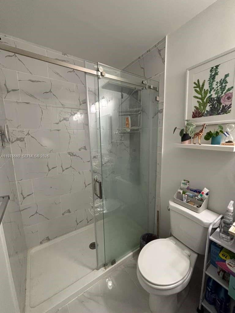 13900 Southwest 259th Street Homestead, FL 33032 - Photo 11 of 23 a bathroom with a toilet and a shower