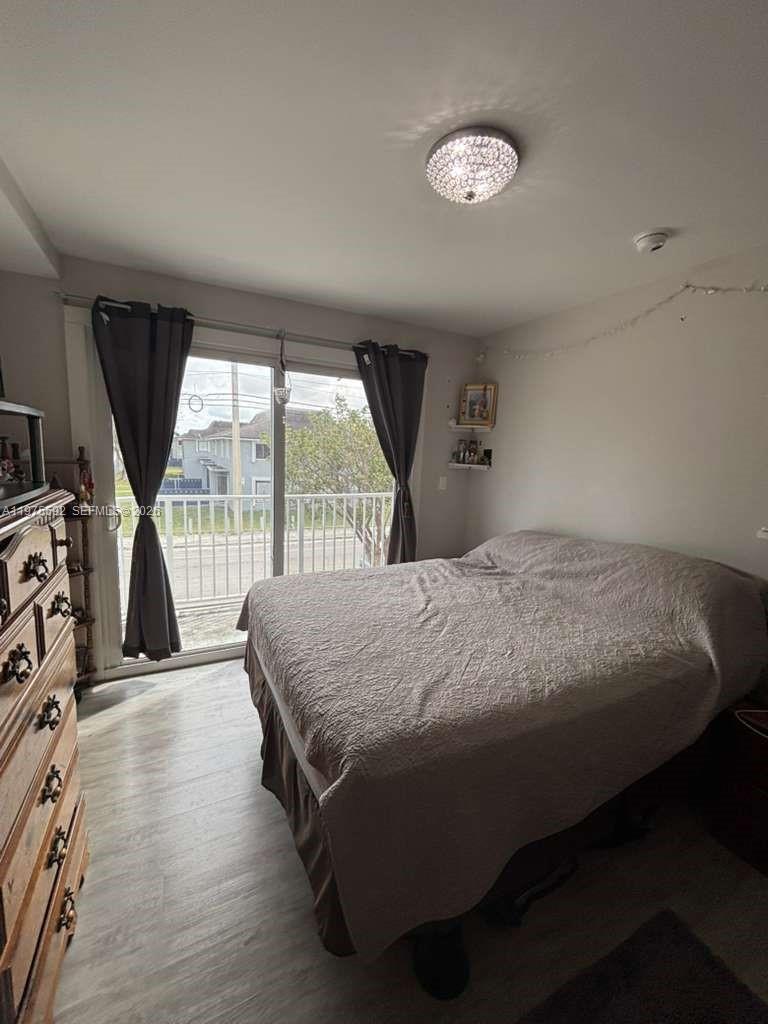 13900 Southwest 259th Street Homestead, FL 33032 - Photo 12 of 23 a bed sitting in a room next to a window