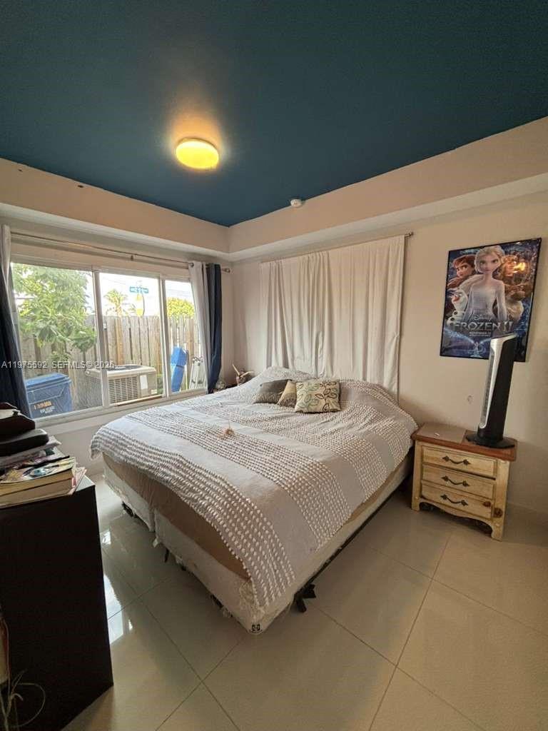 13900 Southwest 259th Street Homestead, FL 33032 - Photo 16 of 23 a bedroom with a bed and a balcony