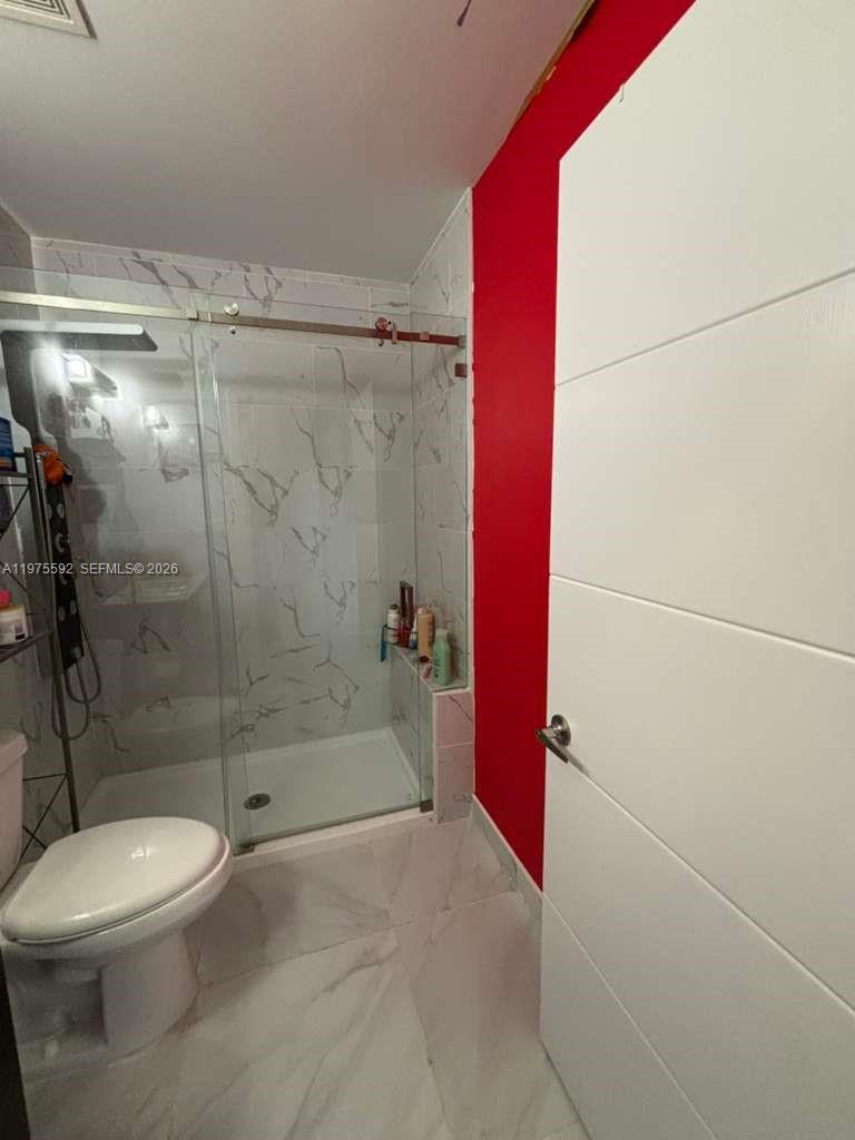 13900 Southwest 259th Street Homestead, FL 33032 - Photo 17 of 23 a bathroom with a toilet and shower