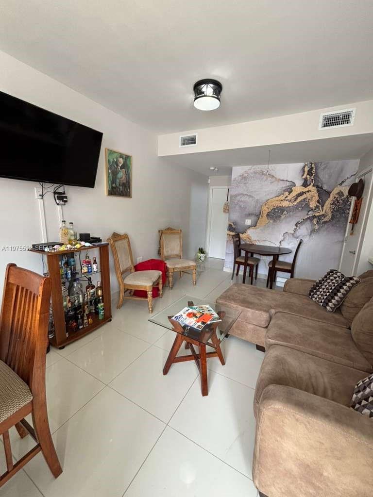 13900 Southwest 259th Street Homestead, FL 33032 - Photo 5 of 23 a bedroom with furniture and a flat screen tv