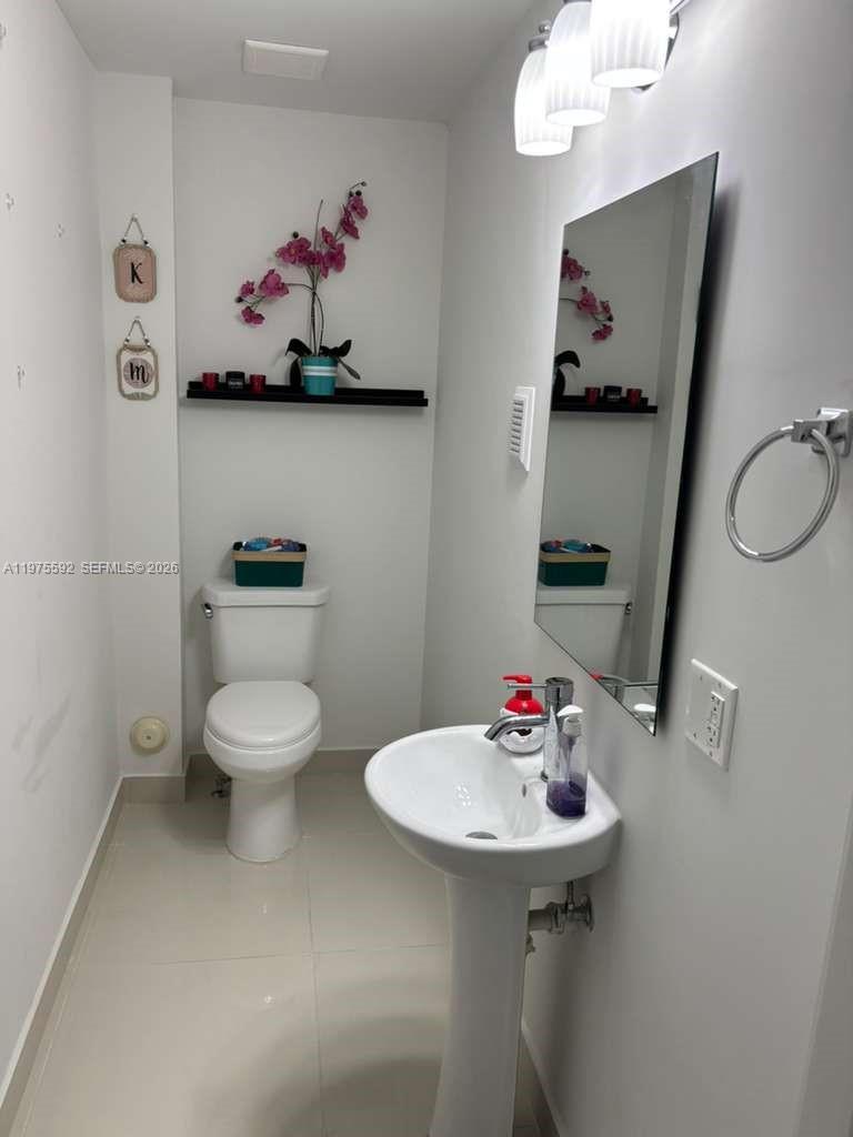 13900 Southwest 259th Street Homestead, FL 33032 - Photo 8 of 23 a bathroom with a sink mirror and toilet