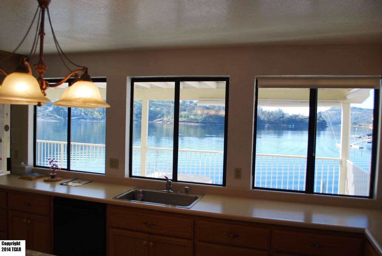 796 Mother Shipton Road Copperopolis, CA 95228 - Photo 8 of 24 a kitchen with large windows and a sink