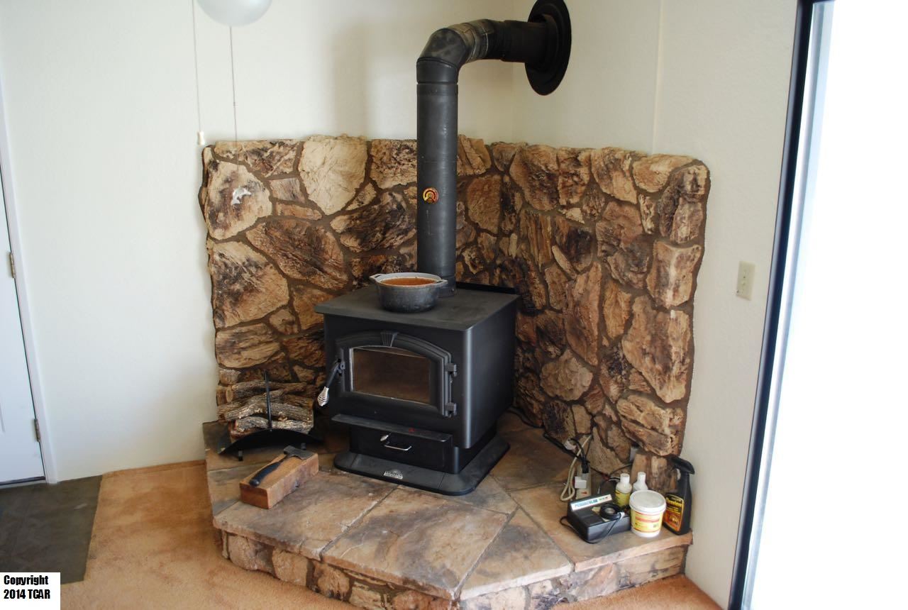 796 Mother Shipton Road Copperopolis, CA 95228 - Photo 10 of 24 a living room with a fireplace