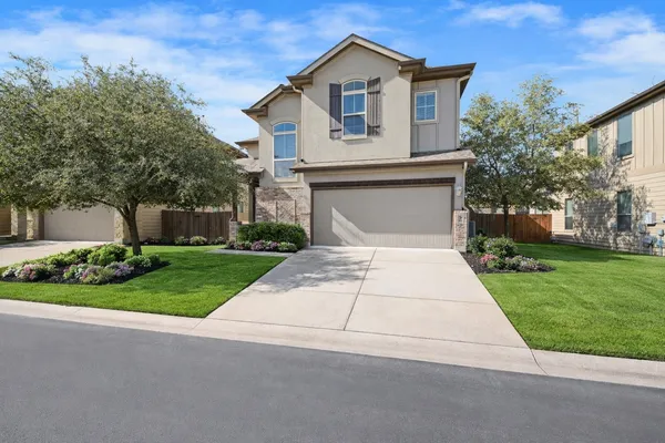 a front view of a house with a yard and garage