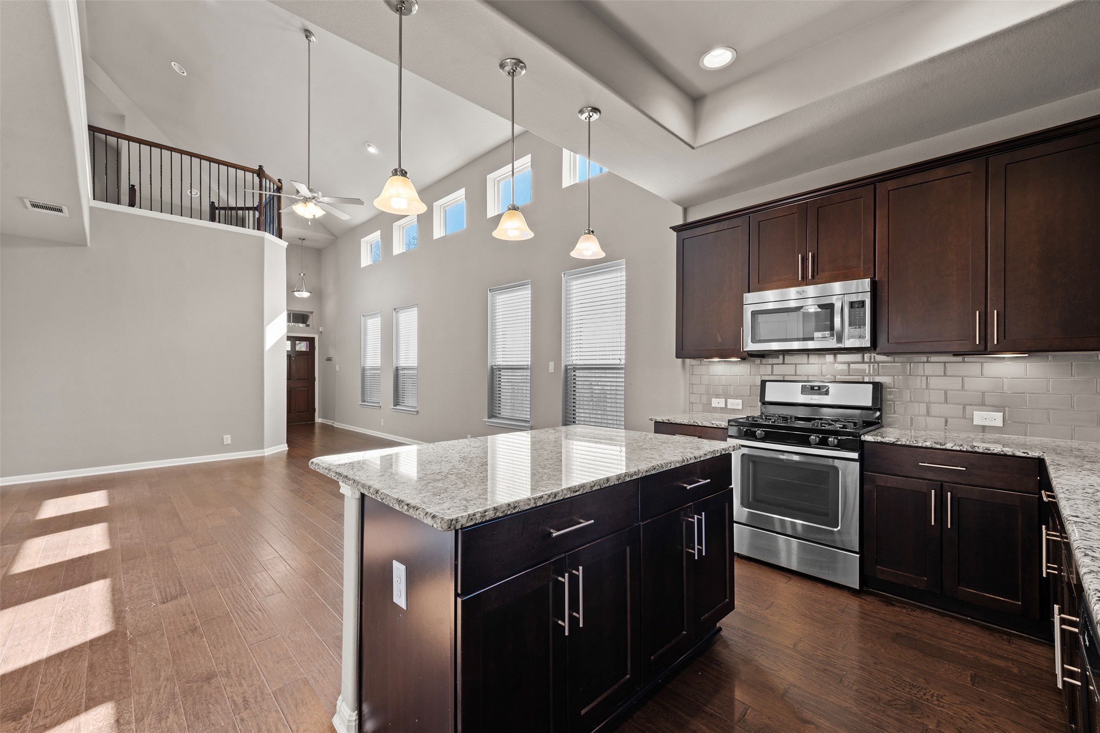 7233 Menchaca Road, Unit 2 Austin, TX 78745 - Photo 15 of 34 a kitchen with kitchen island granite countertop a sink cabinets and stainless steel appliances