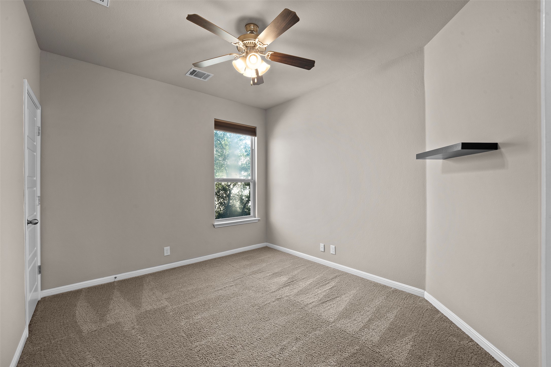 7233 Menchaca Road, Unit 2 Austin, TX 78745 - Photo 23 of 34 an empty room with a window and a fan
