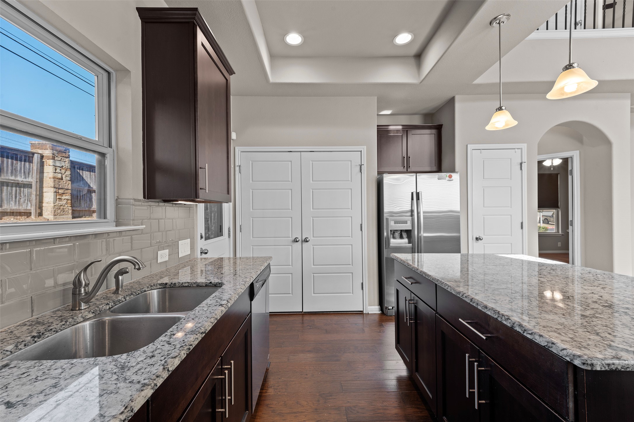 7233 Menchaca Road, Unit 2 Austin, TX 78745 - Photo 10 of 34 a kitchen with granite countertop a sink and a refrigerator