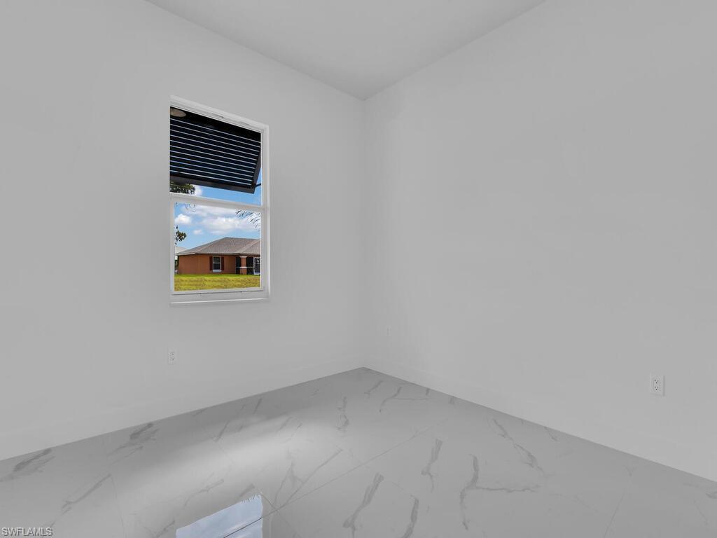 6120 Stratton Road Fort Myers, FL 33905 - Photo 20 of 27 a view of an empty room with wooden floor and a window