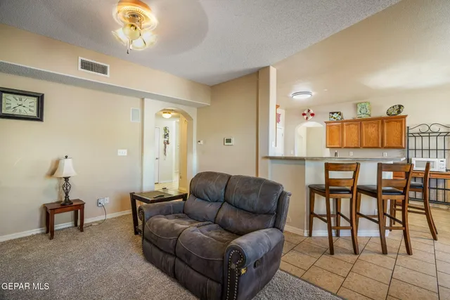 a living room with furniture and a chandelier