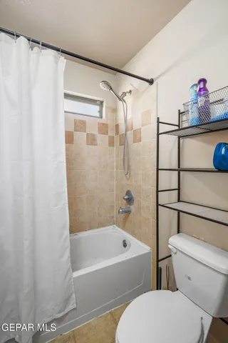 a bedroom with a bed and flat screen tv