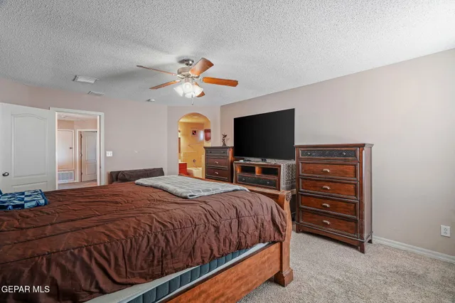 a large bathroom with a glass door shower and a sink