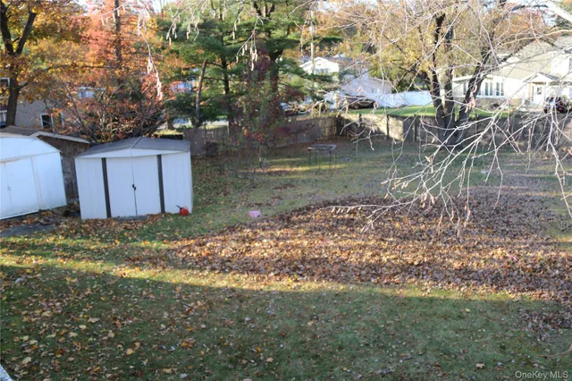 a view of a wooden house with a yard