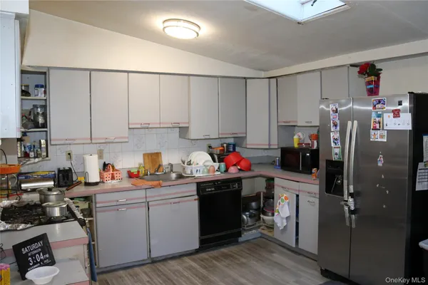 a kitchen with stainless steel appliances a refrigerator sink and cabinets