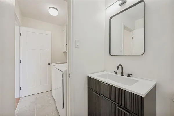 a bathroom with a sink vanity and a mirror