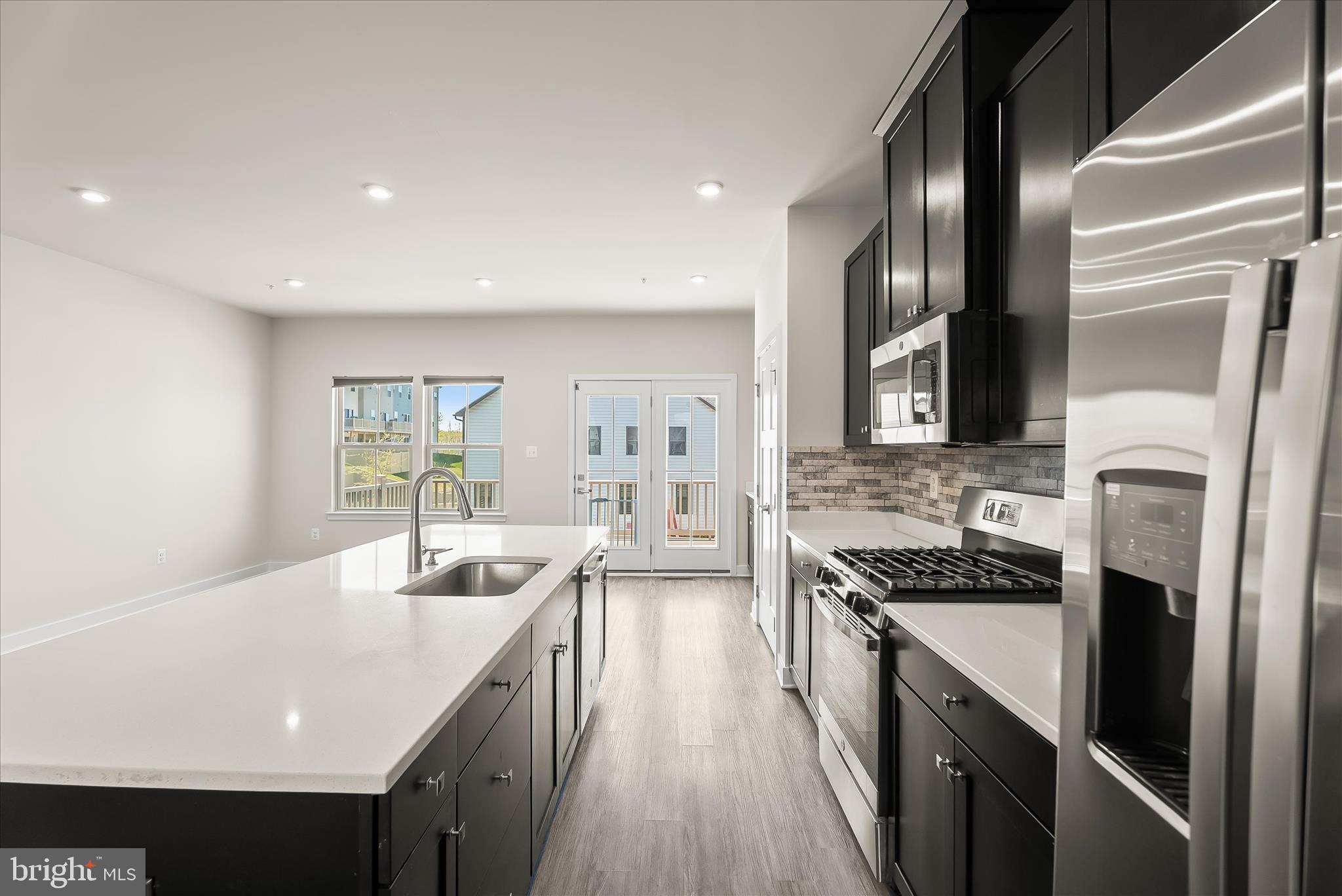6072 Fallfish Court New Market, MD 21774 - Photo 16 of 78 a kitchen with stainless steel appliances granite countertop a sink a stove and a refrigerator
