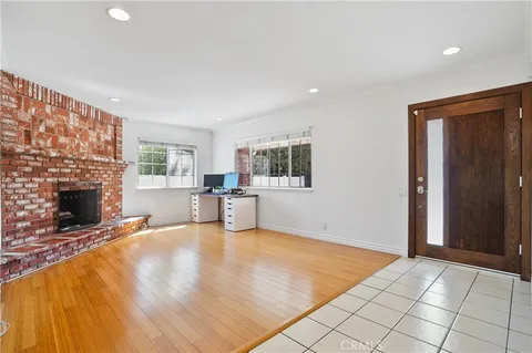 a view of a livingroom with a fireplace and window