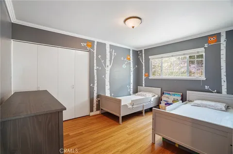 a living room with hard wood floors and a window