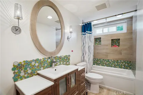 a bathroom with a toilet a sink and a mirror