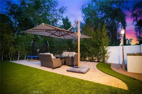 a view of a house with a yard patio and fire pit