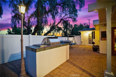 a view of a patio with table and chairs and potted plants