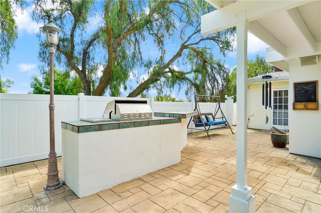 7044 Scarborough Peak Drive West Hills, CA 91307 - Photo 23 of 27 a view of a patio with table and chairs and potted plants