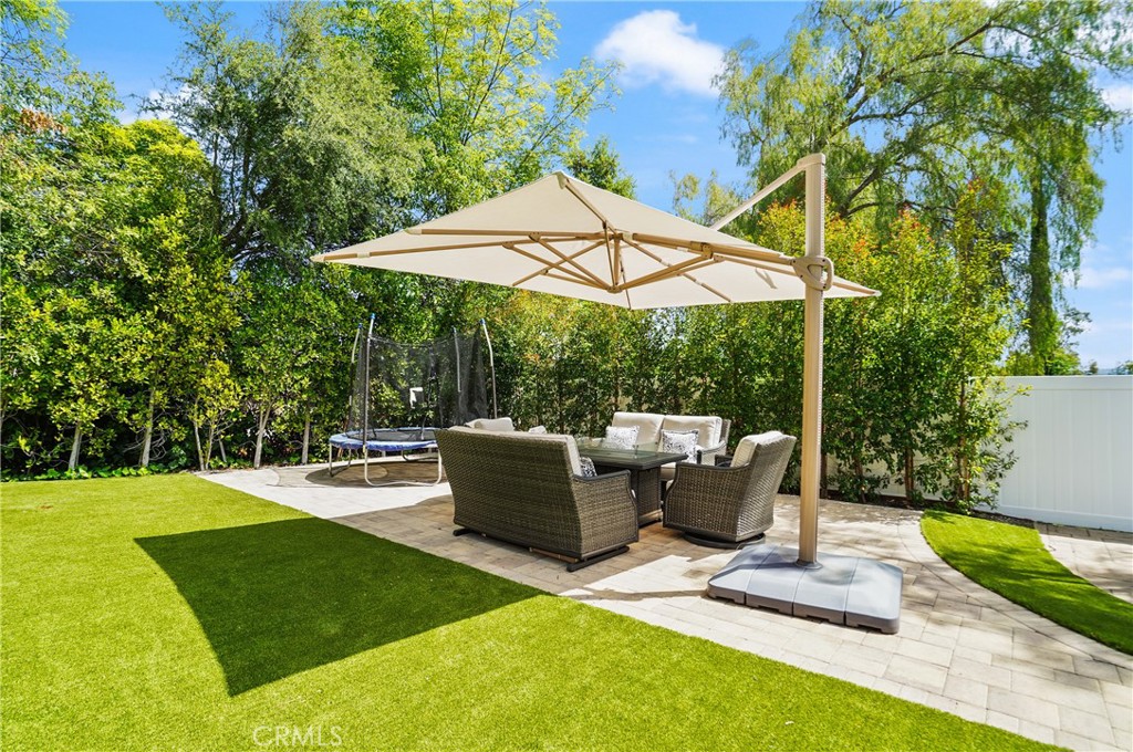 7044 Scarborough Peak Drive West Hills, CA 91307 - Photo 3 of 27 a view of patio with table and chairs under an umbrella