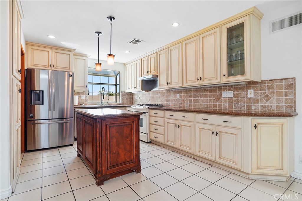 7044 Scarborough Peak Drive West Hills, CA 91307 - Photo 9 of 27 a kitchen with stainless steel appliances granite countertop a refrigerator sink and cabinets