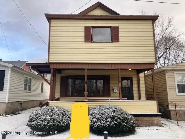 a view of a house with a large window and wooden floor