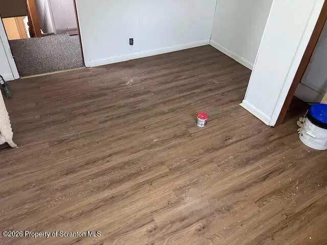 a view of a room with wooden floor