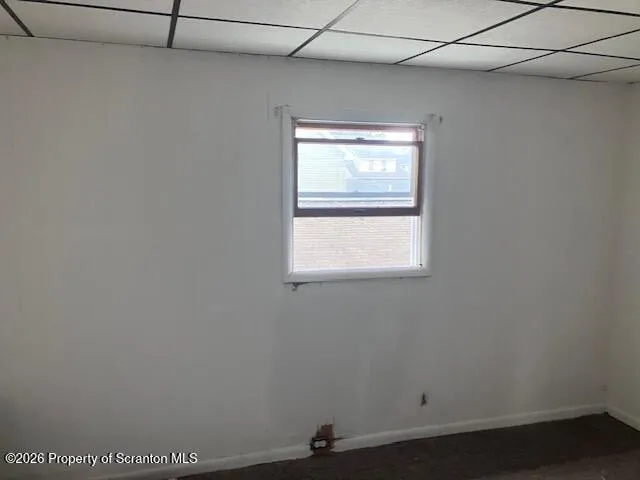 a view of a small space with wooden floor and a window