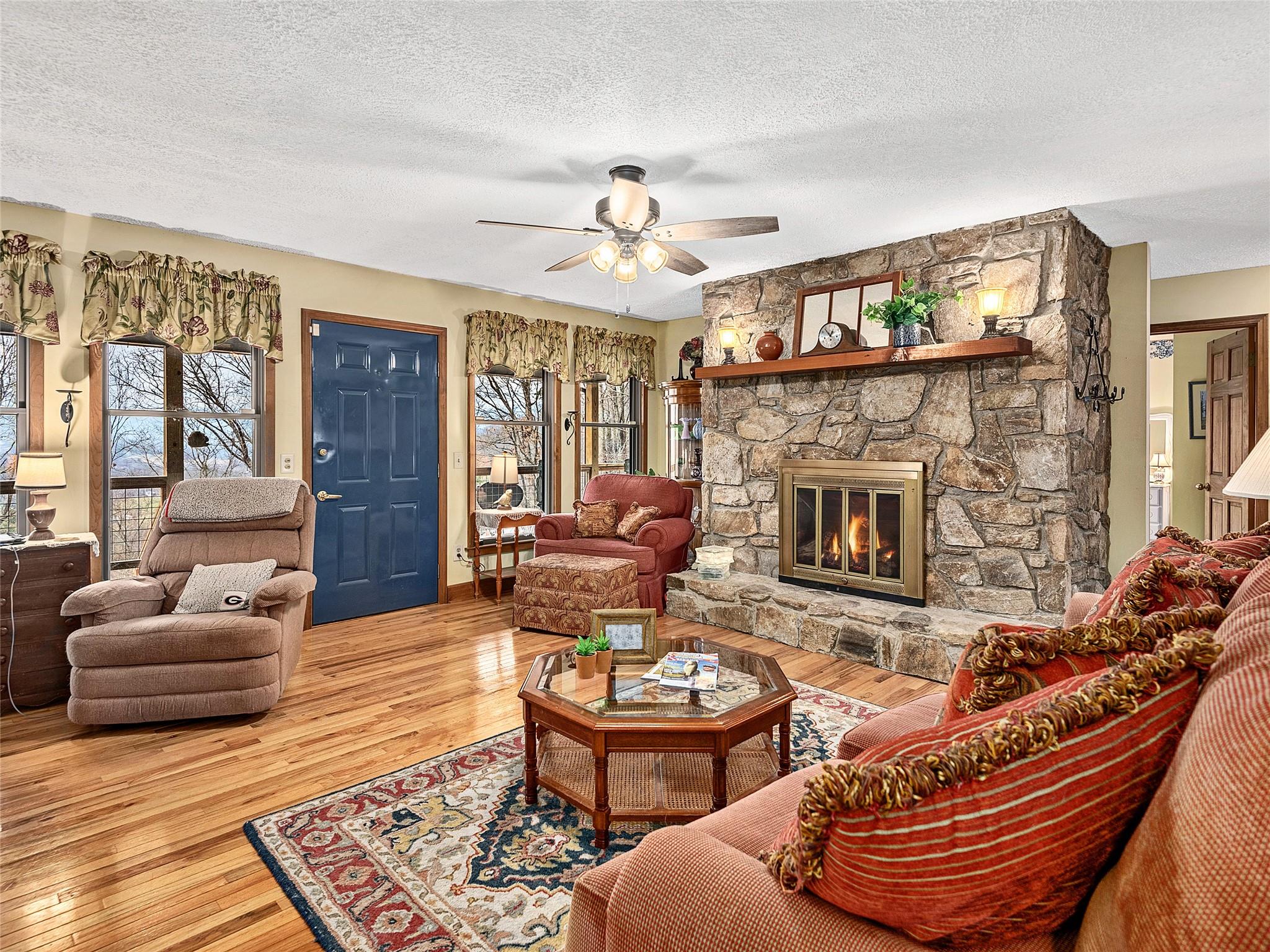 2843 Hyder Mountain Road Clyde, NC 28721 - Photo 5 of 30 a living room with furniture a fireplace and a large window
