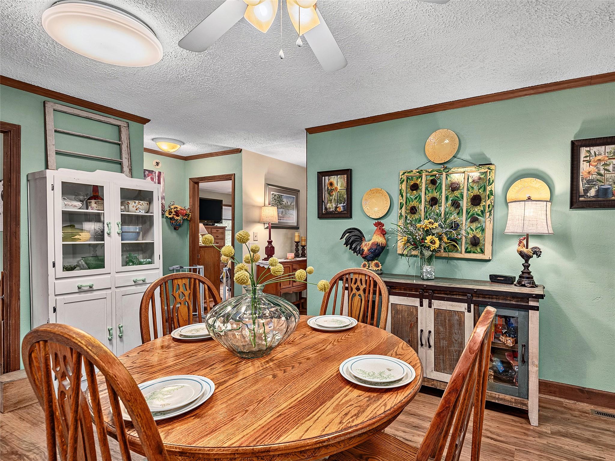 2843 Hyder Mountain Road Clyde, NC 28721 - Photo 8 of 30 a view of a dining room with furniture a chandelier and wooden floor